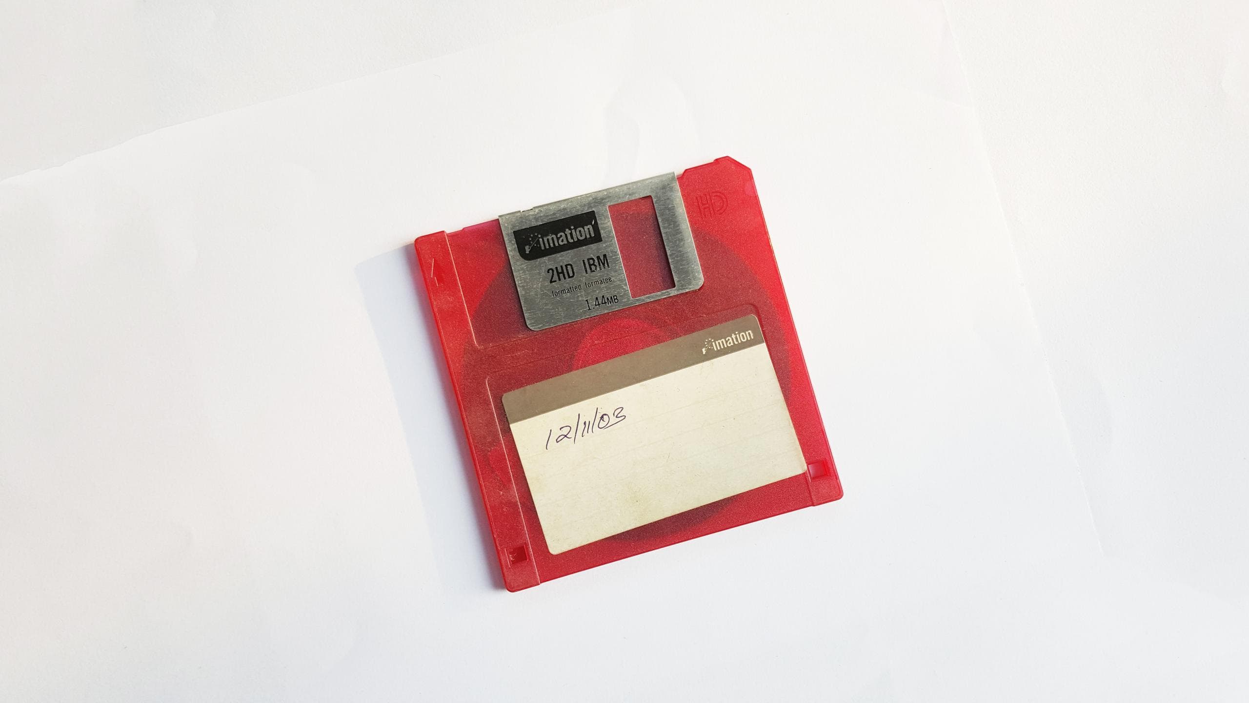 A red floppy disk on a white background.